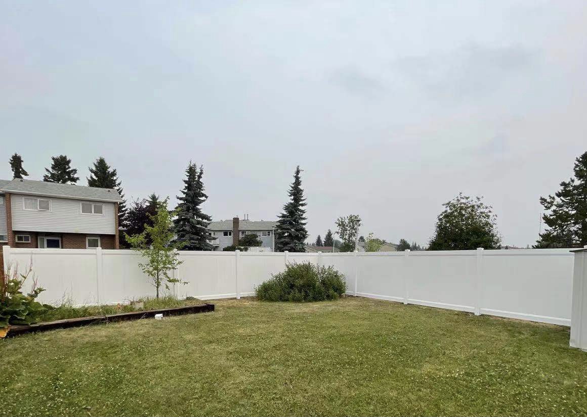 a newly constructed wood fence in the backyard