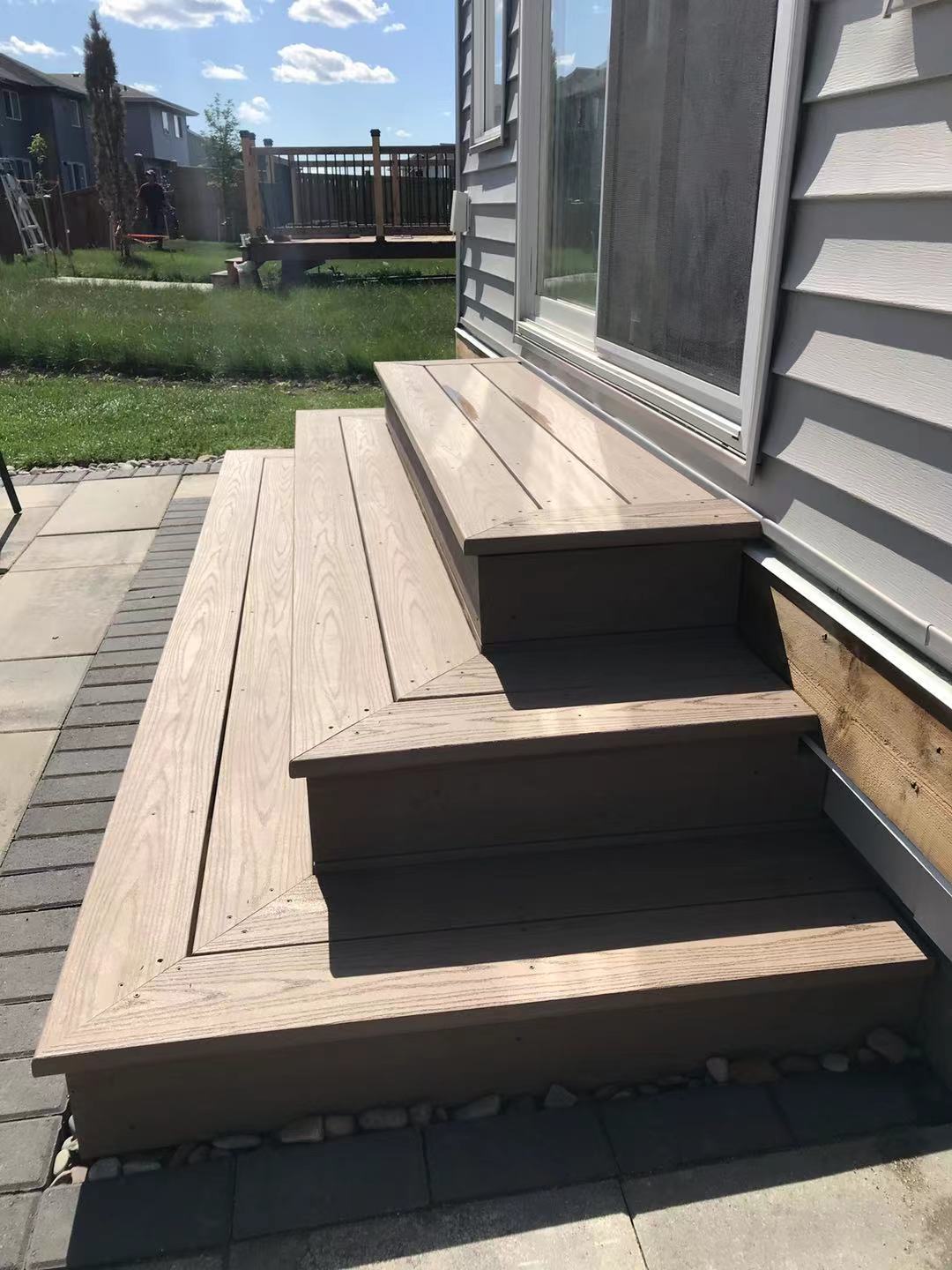 a newly constructed wood deck in the backyard